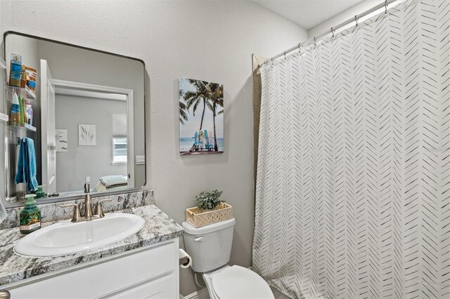 17547 Cantarina Cv, Bradenton, FL 34211 - bathroom featuring vanity, toilet, and curtained shower