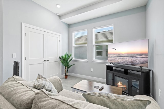 17547 Cantarina Cv, Bradenton, FL 34211 - carpeted living area featuring baseboards and a glass covered fireplace