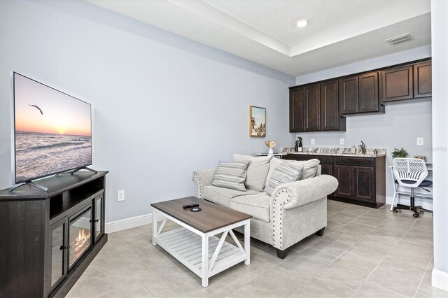 17547 Cantarina Cv, Bradenton, FL 34211 - living area featuring light tile patterned flooring and baseboards