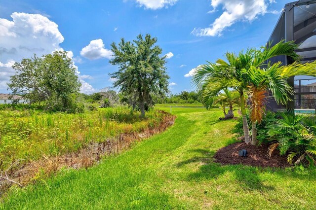 17547 Cantarina Cv, Bradenton, FL 34211 - view of grassy yard with a lanai