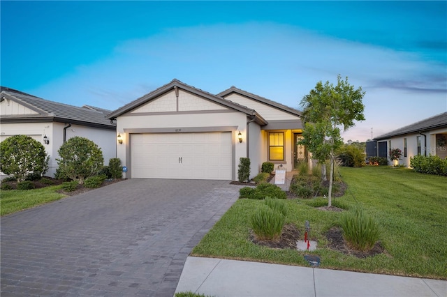 6239 Baywood Ct, Bradenton, FL 34211 - ranch-style house featuring an attached garage, decorative driveway, a front yard, and stucco siding