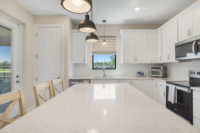 6239 Baywood Ct, Bradenton, FL 34211 - kitchen featuring stainless steel appliances, backsplash, white cabinetry, and light stone counters