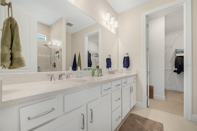 6239 Baywood Ct, Bradenton, FL 34211 - bathroom with double vanity, a stall shower, a spacious closet, and tile patterned flooring
