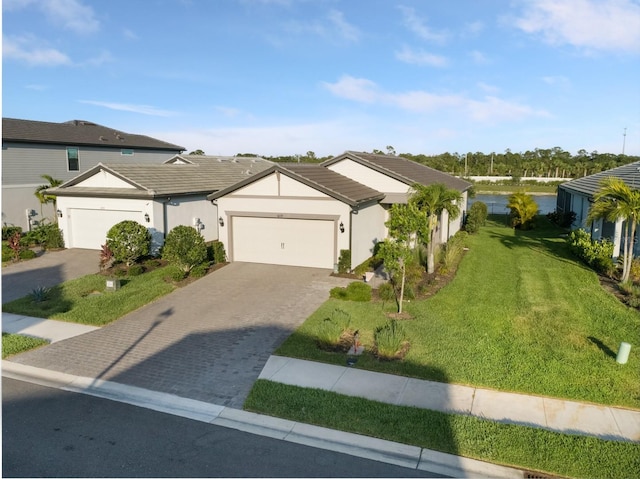 6239 Baywood Ct, Bradenton, FL 34211 - ranch-style house with an attached garage, a front yard, decorative driveway, and stucco siding