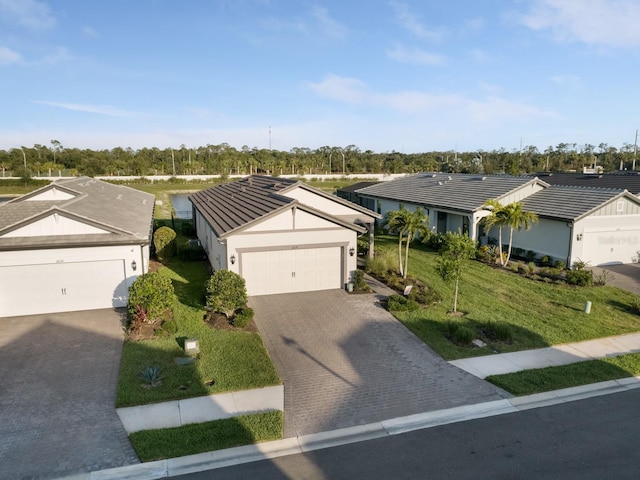 6239 Baywood Ct, Bradenton, FL 34211 - ranch-style house with stucco siding, driveway, an attached garage, a front yard, and a tile roof