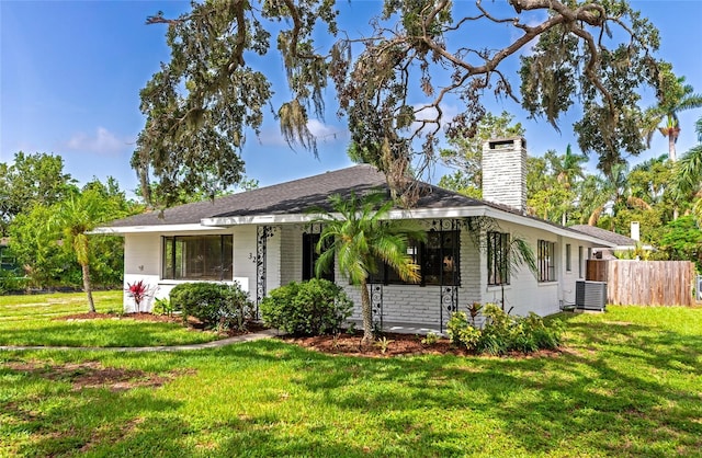 326 25th St W, Bradenton, FL 34205 - view of front of home with a chimney and central AC unit