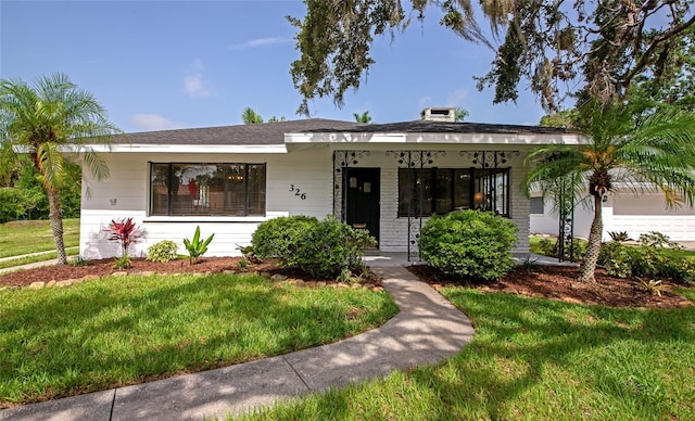 326 25th St W, Bradenton, FL 34205 - bungalow-style house featuring a front lawn and covered porch