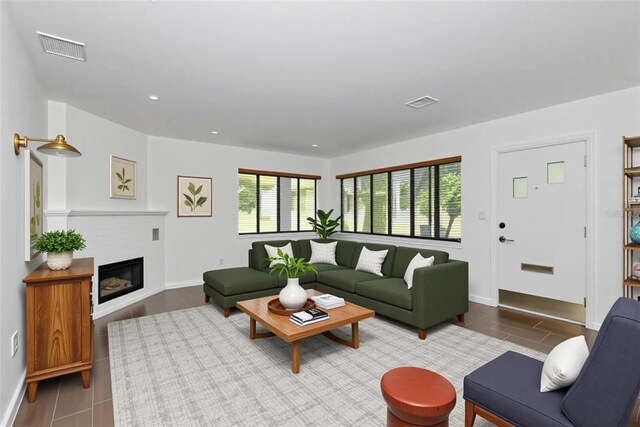 326 25th St W, Bradenton, FL 34205 - living area featuring tile patterned floors, a glass covered fireplace, baseboards, and recessed lighting