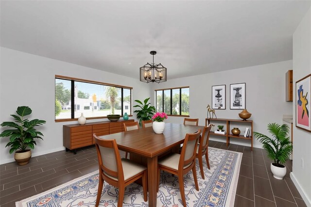 326 25th St W, Bradenton, FL 34205 - dining space featuring a chandelier, dark tile patterned flooring, and baseboards
