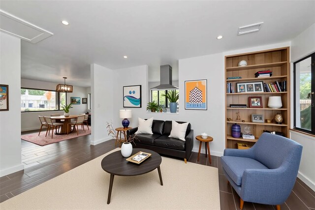 326 25th St W, Bradenton, FL 34205 - living area with dark wood-style floors, baseboards, recessed lighting, and a chandelier