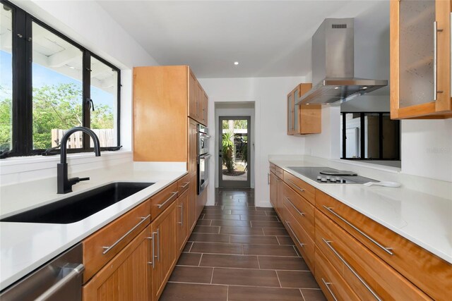 326 25th St W, Bradenton, FL 34205 - kitchen featuring island exhaust hood, a sink, stainless steel appliances, light countertops, and brown cabinets