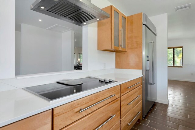 326 25th St W, Bradenton, FL 34205 - kitchen with wall chimney range hood, light countertops, glass insert cabinets, high end refrigerator, and recessed lighting