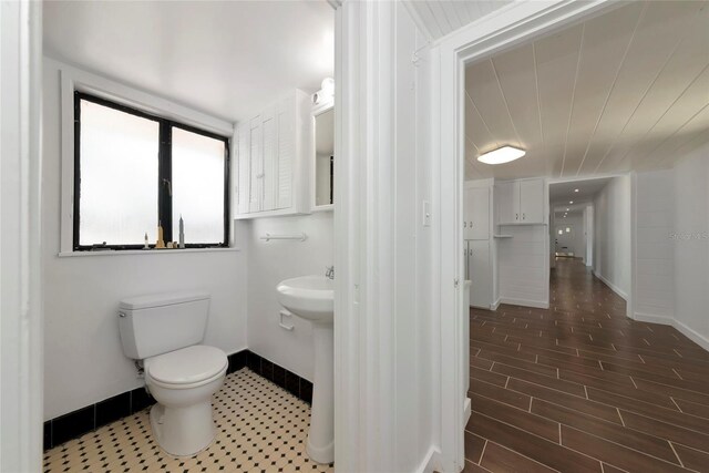 326 25th St W, Bradenton, FL 34205 - half bath with baseboards, toilet, and wood finished floors