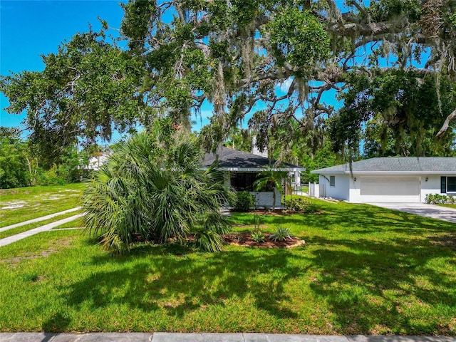 326 25th St W, Bradenton, FL 34205 - view of grassy yard with an attached garage and driveway