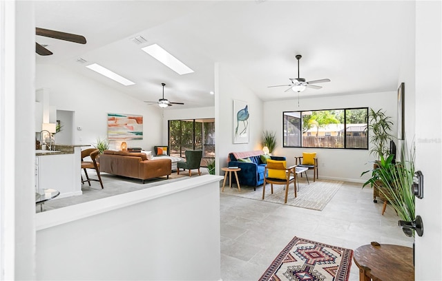 4253 Prairie View Dr, Sarasota, FL 34232 - living area featuring ceiling fan, vaulted ceiling, a skylight, and baseboards