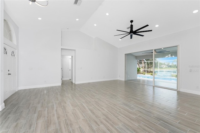 10055 Franklin Dr, Englewood, FL 34224 - unfurnished living room with a ceiling fan, recessed lighting, light wood-type flooring, baseboards, and high vaulted ceiling