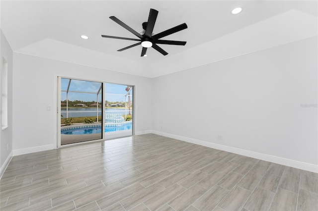 10055 Franklin Dr, Englewood, FL 34224 - empty room featuring a tray ceiling, baseboards, ceiling fan, light wood finished floors, and recessed lighting