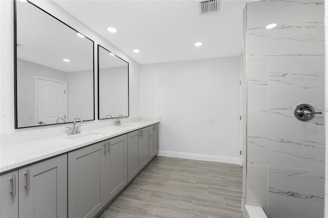 10055 Franklin Dr, Englewood, FL 34224 - bathroom featuring double vanity, baseboards, a marble finish shower, and recessed lighting