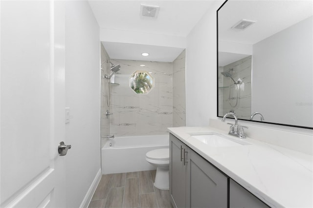 10055 Franklin Dr, Englewood, FL 34224 - bathroom with vanity, toilet, bathing tub / shower combination, baseboards, and wood finish floors