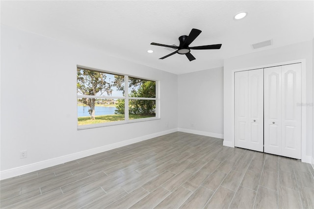 10055 Franklin Dr, Englewood, FL 34224 - unfurnished bedroom with baseboards, recessed lighting, light wood-style floors, a closet, and ceiling fan