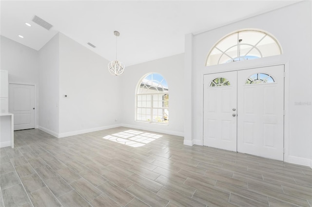 10055 Franklin Dr, Englewood, FL 34224 - entrance foyer featuring high vaulted ceiling, plenty of natural light, and baseboards