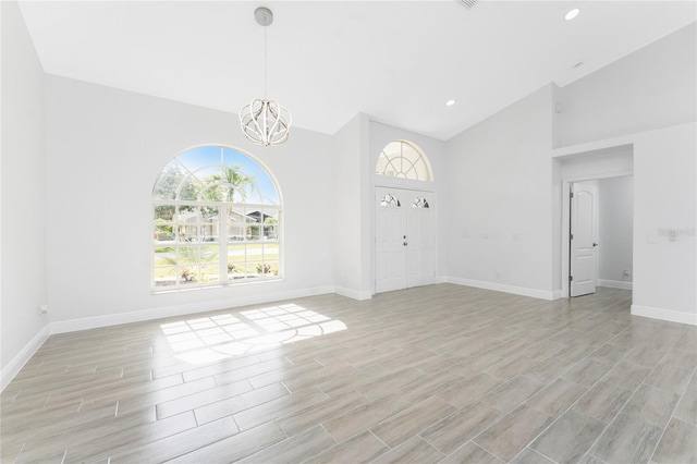 10055 Franklin Dr, Englewood, FL 34224 - entrance foyer featuring high vaulted ceiling, a chandelier, light wood finished floors, baseboards, and recessed lighting