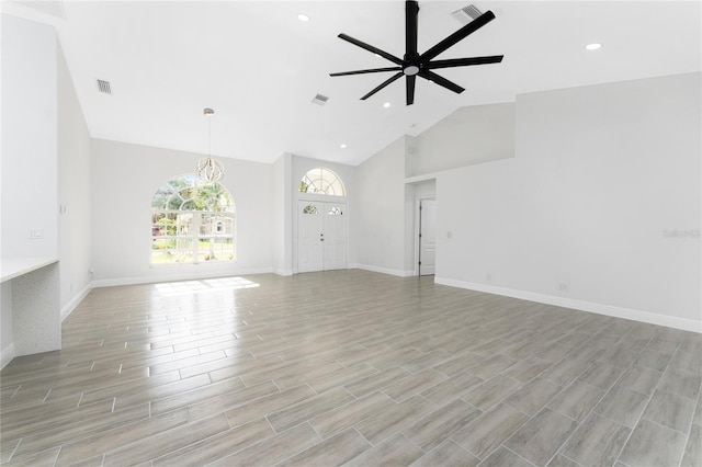 10055 Franklin Dr, Englewood, FL 34224 - unfurnished living room featuring a ceiling fan, high vaulted ceiling, light wood-style floors, baseboards, and recessed lighting