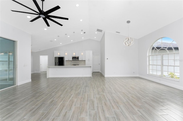 10055 Franklin Dr, Englewood, FL 34224 - unfurnished living room featuring high vaulted ceiling, light wood-style flooring, baseboards, recessed lighting, and a ceiling fan