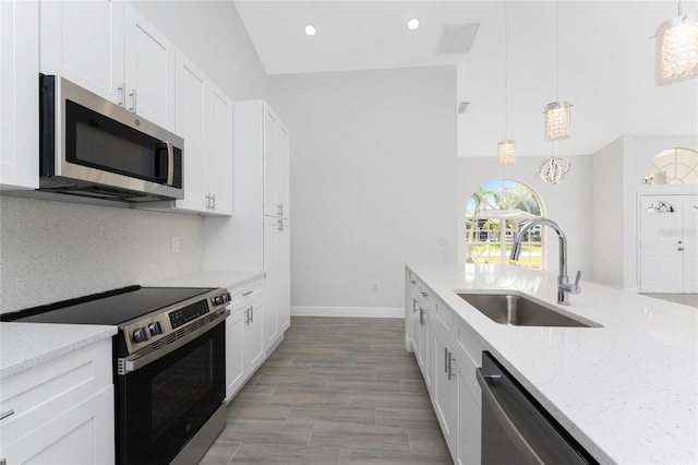 10055 Franklin Dr, Englewood, FL 34224 - kitchen featuring stainless steel appliances, a sink, tasteful backsplash, white cabinets, and recessed lighting