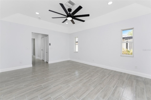 10055 Franklin Dr, Englewood, FL 34224 - unfurnished room featuring a raised ceiling, healthy amount of natural light, a ceiling fan, recessed lighting, and baseboards