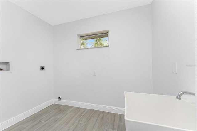 10055 Franklin Dr, Englewood, FL 34224 - laundry room with hookup for an electric dryer, baseboards, wood finish floors, and washer hookup
