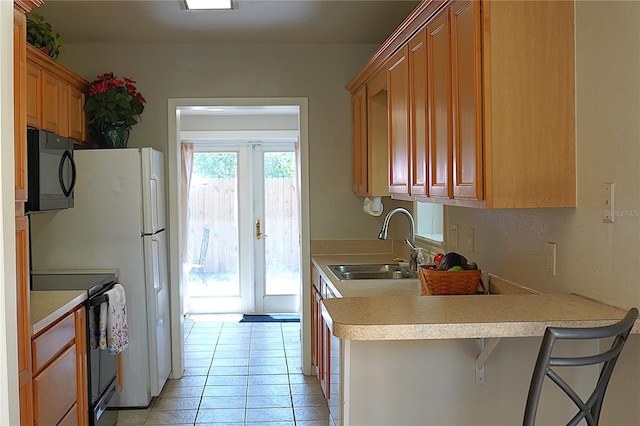 204 36th St W, Bradenton, FL 34205 - kitchen with black microwave, electric range oven, a sink, and light countertops