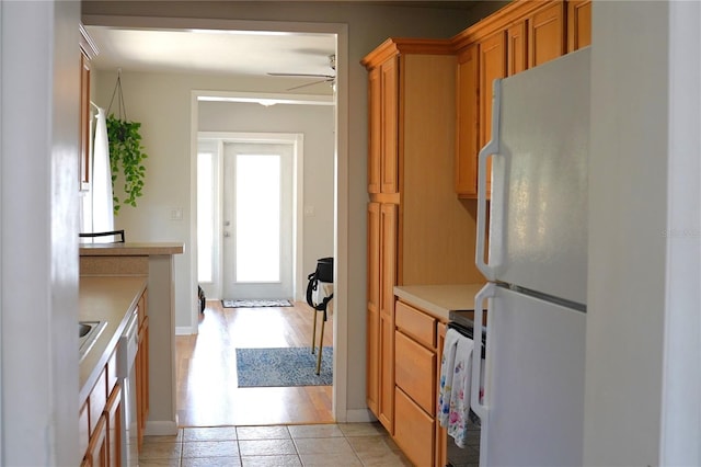 204 36th St W, Bradenton, FL 34205 - kitchen with freestanding refrigerator, range, light countertops, ceiling fan, and light tile patterned floors