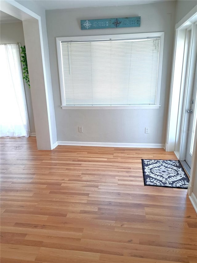 204 36th St W, Bradenton, FL 34205 - spare room with baseboards, light wood-type flooring, and healthy amount of natural light