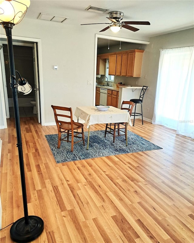 204 36th St W, Bradenton, FL 34205 - dining space featuring ceiling fan, light wood-type flooring, and baseboards