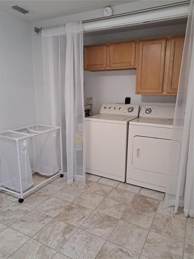 204 36th St W, Bradenton, FL 34205 - washroom with washing machine and dryer, cabinet space, and light stone finish floors