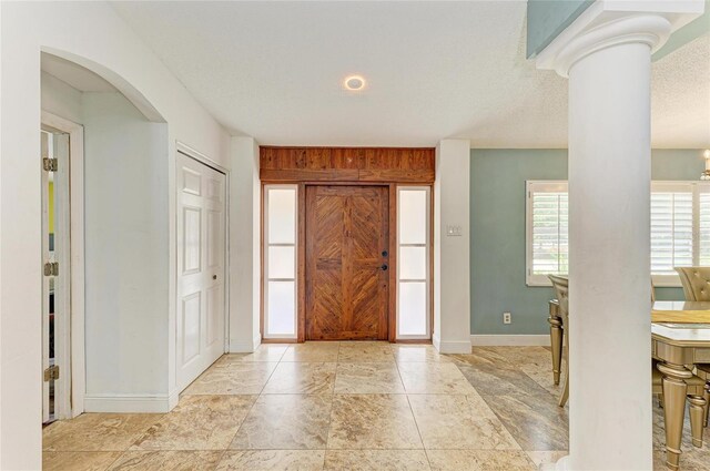 2726 Desoto Rd, Sarasota, FL 34234 - entrance foyer with baseboards, arched walkways, and ornate columns