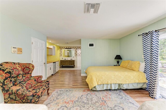 2726 Desoto Rd, Sarasota, FL 34234 - bedroom with light wood-style floors, ensuite bath, and wine cooler