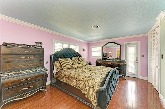 2726 Desoto Rd, Sarasota, FL 34234 - bedroom featuring crown molding, dark wood-type flooring, baseboards, a textured ceiling, and access to exterior