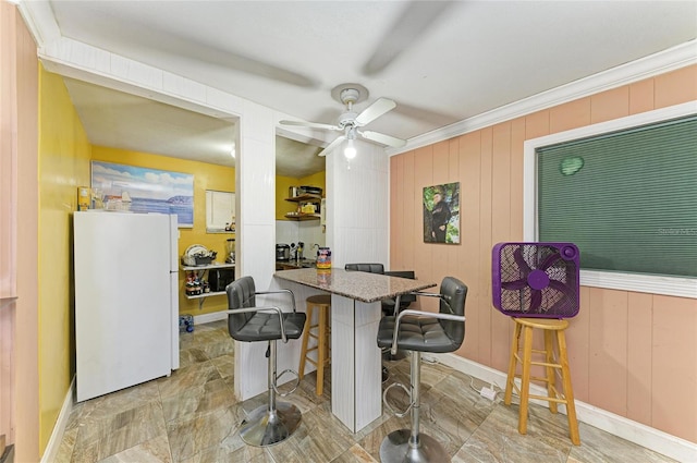 2726 Desoto Rd, Sarasota, FL 34234 - dining area with a ceiling fan, baseboards, and crown molding