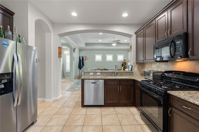 5047 Newport News Cir, Bradenton, FL 34211 - kitchen featuring black appliances, a sink, a ceiling fan, arched walkways, and dark brown cabinets