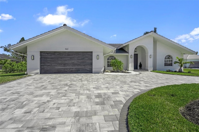 1527 Buoy Ln, Osprey, FL 34229 - ranch-style home with decorative driveway, an attached garage, and stucco siding