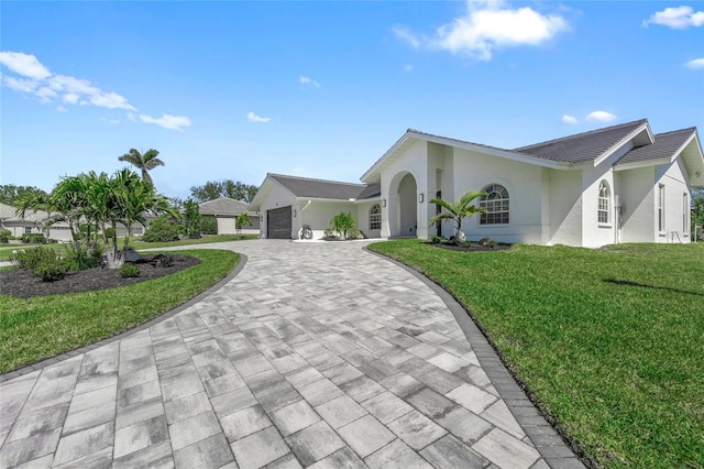 1527 Buoy Ln, Osprey, FL 34229 - single story home with decorative driveway, a front lawn, an attached garage, and stucco siding