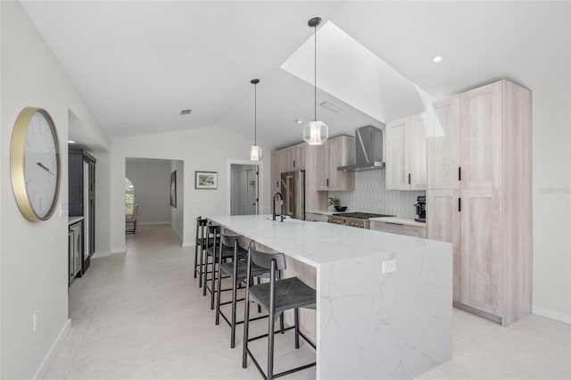 1527 Buoy Ln, Osprey, FL 34229 - kitchen with wall chimney range hood, high end refrigerator, a breakfast bar area, a spacious island, and vaulted ceiling