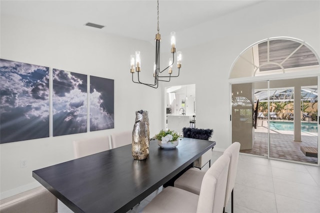 1527 Buoy Ln, Osprey, FL 34229 - tiled dining room with a chandelier, a towering ceiling, and baseboards