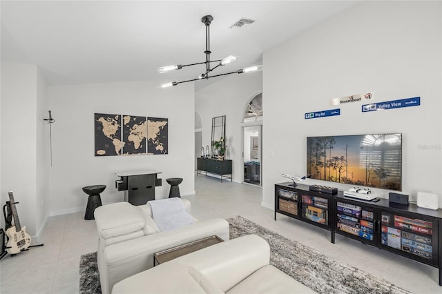 1527 Buoy Ln, Osprey, FL 34229 - living room with a chandelier, high vaulted ceiling, and baseboards