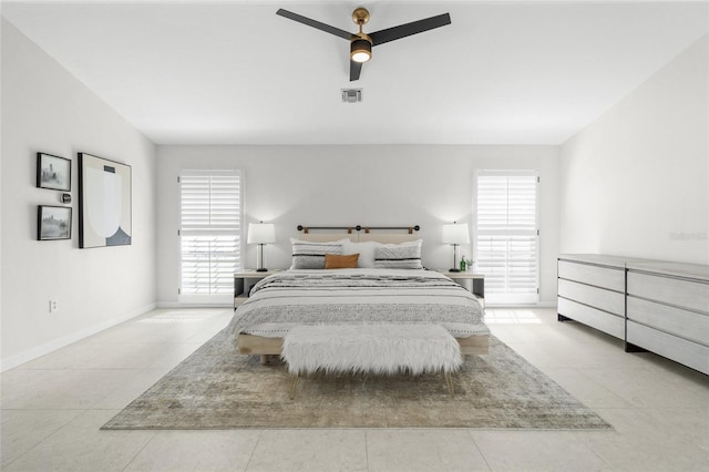 1527 Buoy Ln, Osprey, FL 34229 - bedroom featuring multiple windows, light tile patterned floors, baseboards, and a ceiling fan
