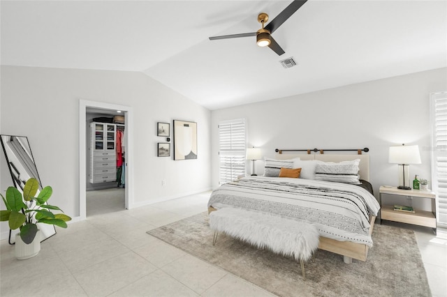 1527 Buoy Ln, Osprey, FL 34229 - bedroom with vaulted ceiling, a walk in closet, light tile patterned flooring, ceiling fan, and baseboards