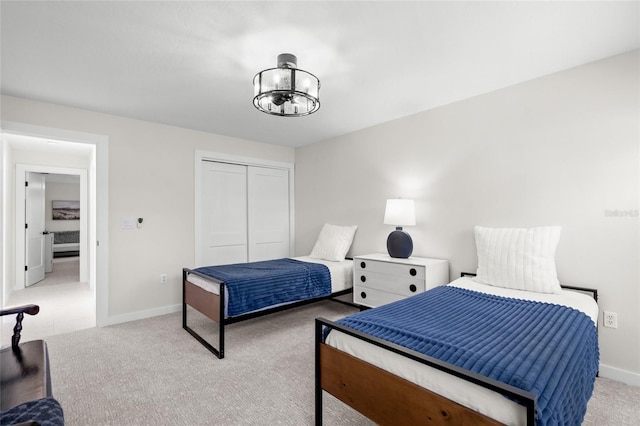 1527 Buoy Ln, Osprey, FL 34229 - bedroom featuring carpet flooring, a chandelier, a closet, and baseboards
