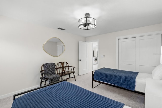 1527 Buoy Ln, Osprey, FL 34229 - bedroom with light colored carpet, a chandelier, baseboards, and a closet